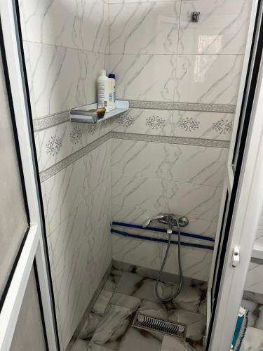 a bathroom with a shower with white marble walls at Zinat outdoor villa in Tétouan