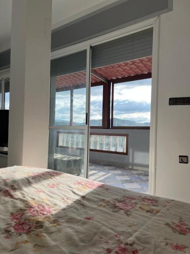 a bedroom with a bed and a large window at Zinat outdoor villa in Tétouan