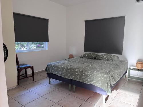 a bedroom with a bed with a large headboard at Casa Dushi Bida in Jan Thiel