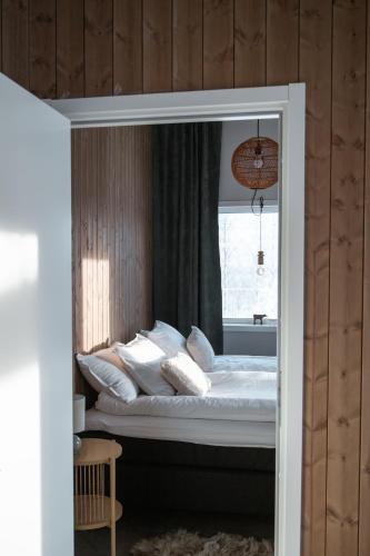a bed with pillows and a window in a room at Mukka Mountain in Ruskola