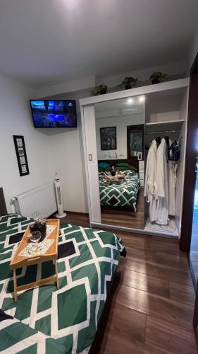 a bedroom with a bed and a table in a room at Apartament Crooked stairs in Zielona Góra