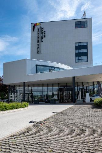 a large white building with a sign on it at Van der Valk Hotel Liège Congres in Liège
