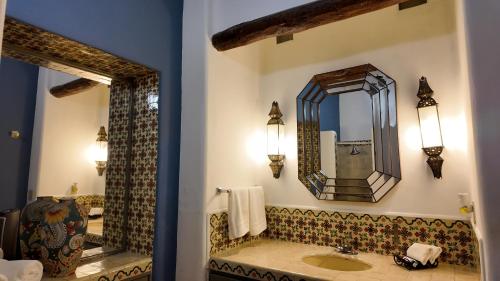 a bathroom with a sink and a mirror at Hacienda del Lago Boutique Hotel in Ajijic