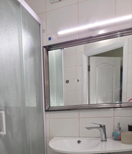 a bathroom with a sink and a mirror at Апартаменты в центре in Chernihiv