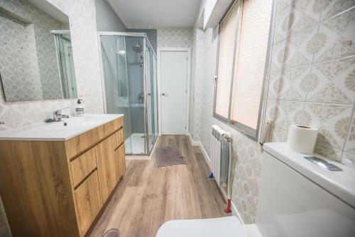 a bathroom with a sink and a shower and a toilet at Villa Artista home in Pontevedra