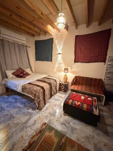 a bedroom with two beds and a couch in it at Omar Cozy in Dahab