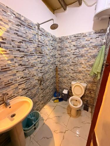 a bathroom with a toilet and a sink at Omar Cozy in Dahab