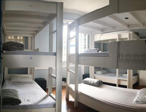 a room with three bunk beds in a room at Hotel Cidade Imperial in Petrópolis