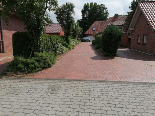 a brick driveway with a car parked on it at Ferienwohnung Haus Lohne in Lohne