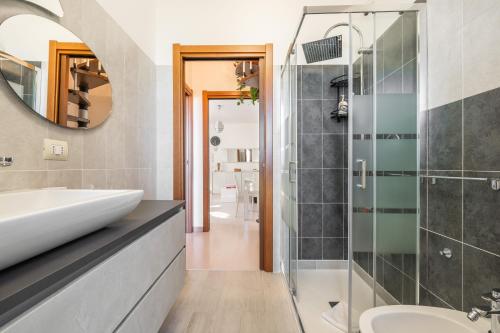 a bathroom with a sink and a shower at Casa Claudia in Elmas