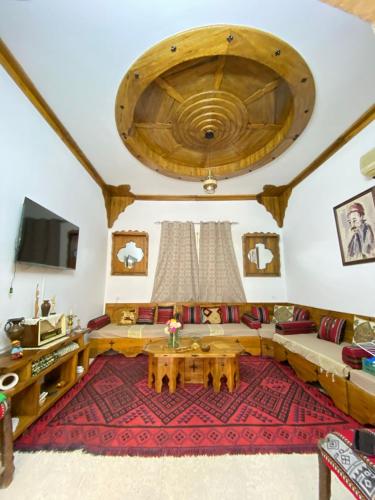 a living room with a large wooden ceiling at Dar hania in Tozeur