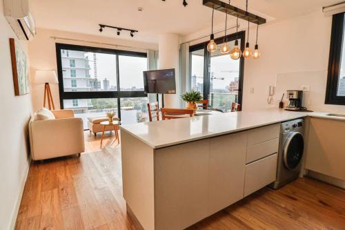 a kitchen with a counter top with a dishwasher at Large Apartment Just Steps from Shopping del Sol in Asunción