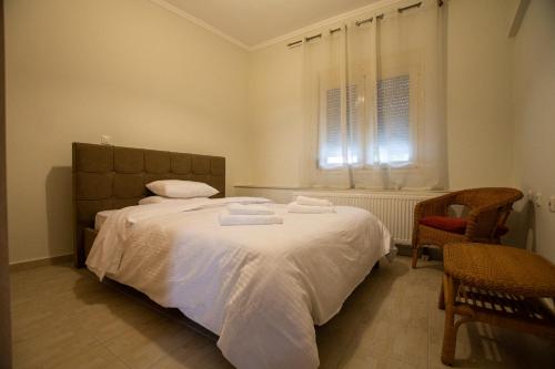 a bedroom with a bed with towels on it at Myrtus House in Kato Loutraki