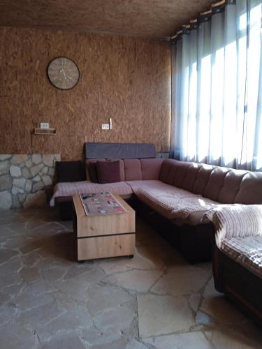 a living room with a couch and a table at -DO- Gradac in Šavnik