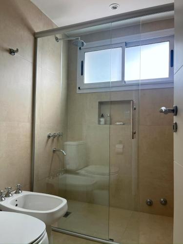 a bathroom with a shower and a toilet and a sink at Carilo Princess in Carilo