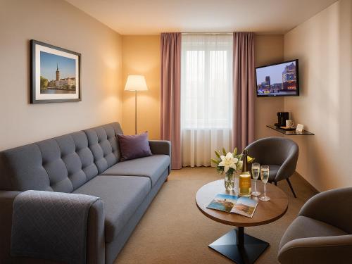 ein Wohnzimmer mit Sofa und Tisch in der Unterkunft Hotel Hafentor in Hamburg