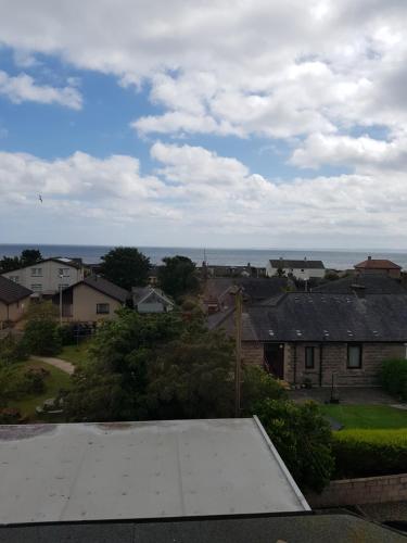a view of a town with houses and the ocean at Aboukir Hotel in Panbride