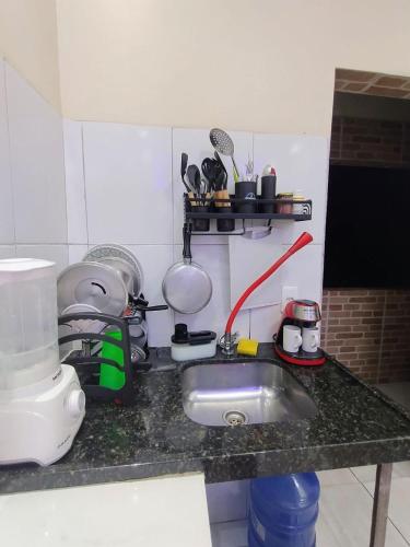 a kitchen counter with a sink and a mixer at Casa completa aconchegante proximo a praia in São Luís