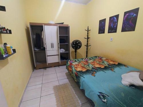 a bedroom with a bed and a tv in it at Casa completa aconchegante proximo a praia in São Luís