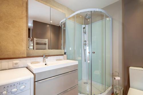 a bathroom with a sink and a glass shower at Maison - Le Petit Bussac in Aigne