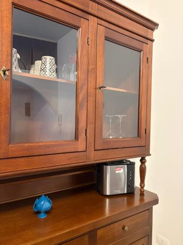 a wooden cabinet with a microwave on a table at Sea Breeze Terrace in Monopoli