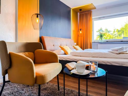 a hotel room with a bed and a chair and a table at Blissberg Winterberg in Winterberg