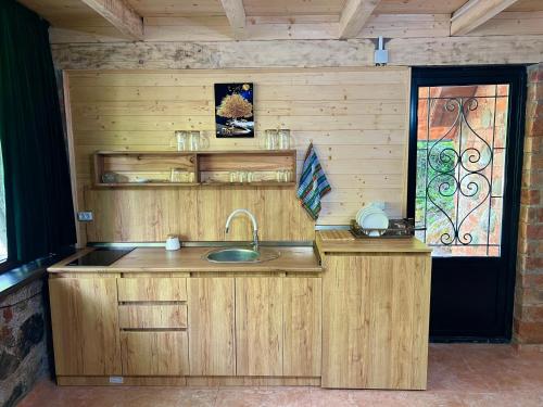 a kitchen with a sink and a window at kirke in Tsesi
