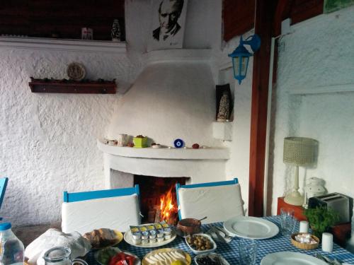 a table with a fireplace with food on it at Amazon Antique in Selcuk