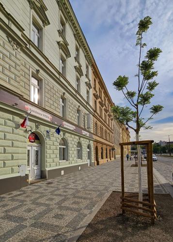 a small tree in front of a building at Residence Vysta in Prague