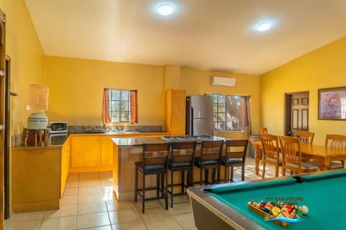 a kitchen with a pool table in a room at Paradise home in Rancho Percebu in San Felipe