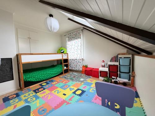 a childs bedroom with a bunk bed and a rug at Spacious flat 15 min to the beach in Falkenberg