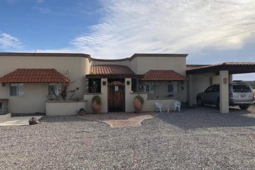 a house with a car parked in front of it at Mountain side Delight - Palapas house San Felipe Vacation Rental in San Felipe