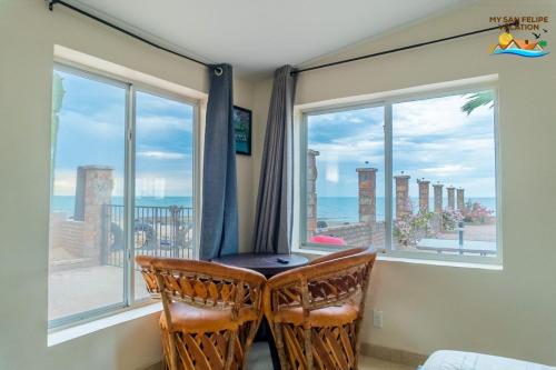 a room with two chairs in front of a window at Rancho Percebu Beach Studio 4 in San Felipe