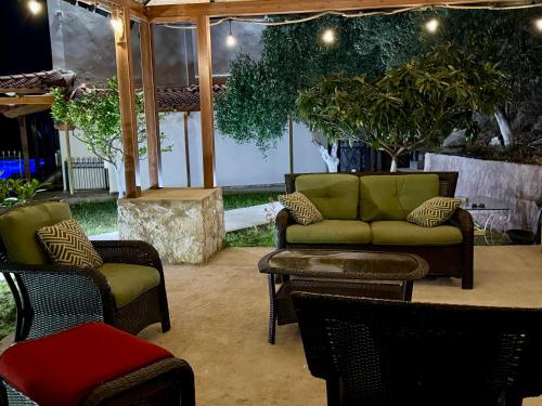 a patio with chairs and a couch and a table at VILA ELEZI Piqeras in Borsh