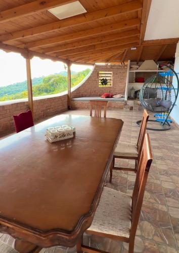 a dining room with a wooden table and chairs at VILA ELEZI Piqeras in Borsh