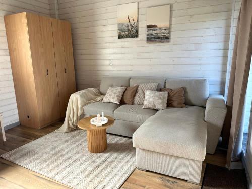 a living room with a couch and a table at Leia Kodu Private Garden House with Terrace & Parking in Rakvere in Rakvere