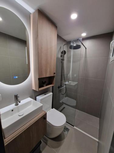 a bathroom with a toilet and a sink and a shower at Blue Yard in Lepetani