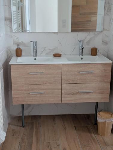 a bathroom with a sink and a mirror at Jardin de Sévigné à Grignan in Grignan