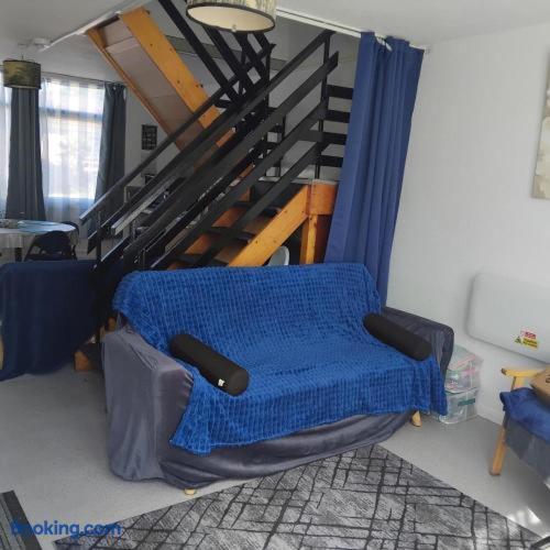 a room with a chair with a blue blanket at Dawlish Warren Welcome family holiday park South Devon Willow villa Welcome2Warren in Dawlish Warren
