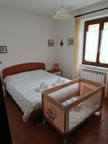 a bedroom with a bed and a window at Ca' tommy in Ceppo Morelli