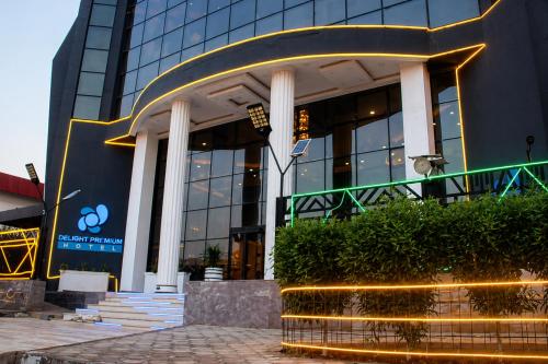 a building with a fountain in front of it at Delight Premium Hotel in Djibouti