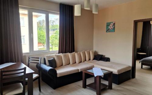 a living room with a couch and a window at Belogradchik View Apartment in Belogradchik