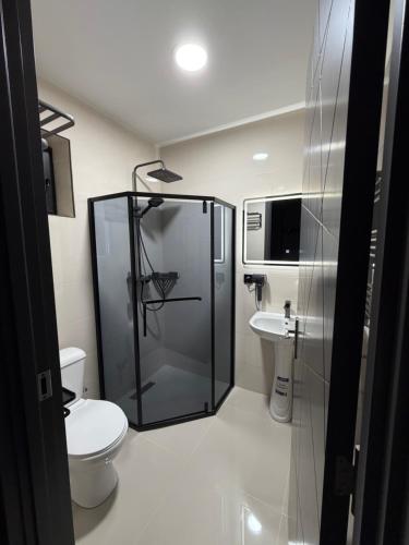 a bathroom with a shower and a toilet and a sink at Hotel DIAMOND - სასტუმრო დაიმონდ in Akhaltsikhe
