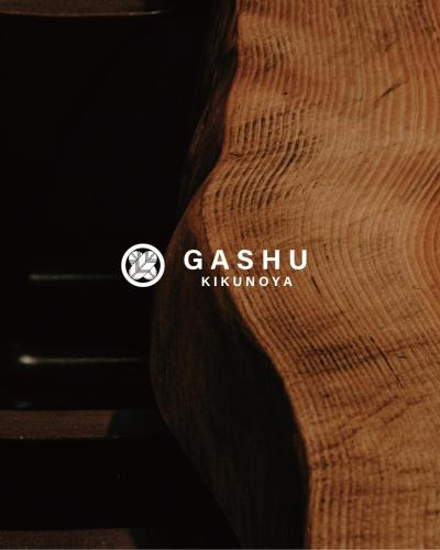 a close up of a wooden table with a logo on it at KIKUNOYA-gashu- in Nagoya