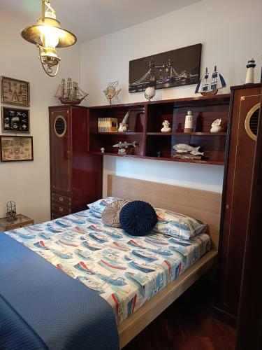 a bedroom with a bed with a tv on the wall at Le Petite Maison in Andria