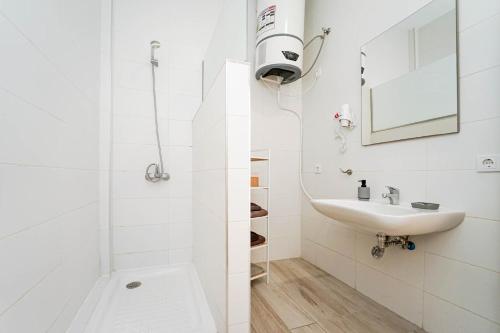 a white bathroom with a shower and a sink at Sunny Day Deluxe 10 in Arguineguín