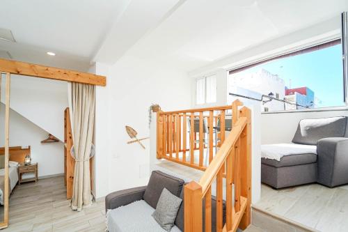 a living room with a staircase and a couch at Sunny Day Deluxe 10 in Arguineguín