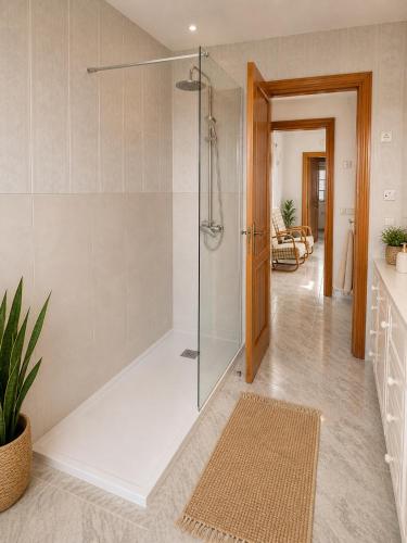 a bathroom with a shower with a glass door at Villa Savanna Spacious villa with private pool near the beach in Cala en Blanes