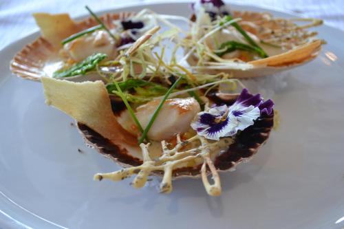 a plate of food on a white plate at The Originals Boutique, Hôtel Les Quatre Salines, Le Mont Saint-Michel Sud in Roz-sur-Couesnon