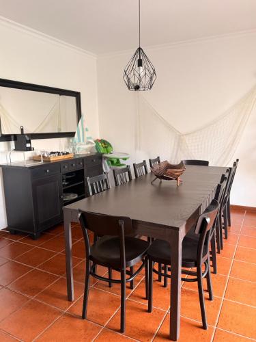 a dining room with a table and chairs at Carminho beach house in Vila do Conde
